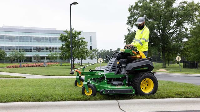 landscaper using John Deere z900 mower