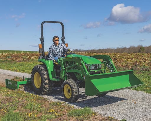 john deere compact tractor on gravel road